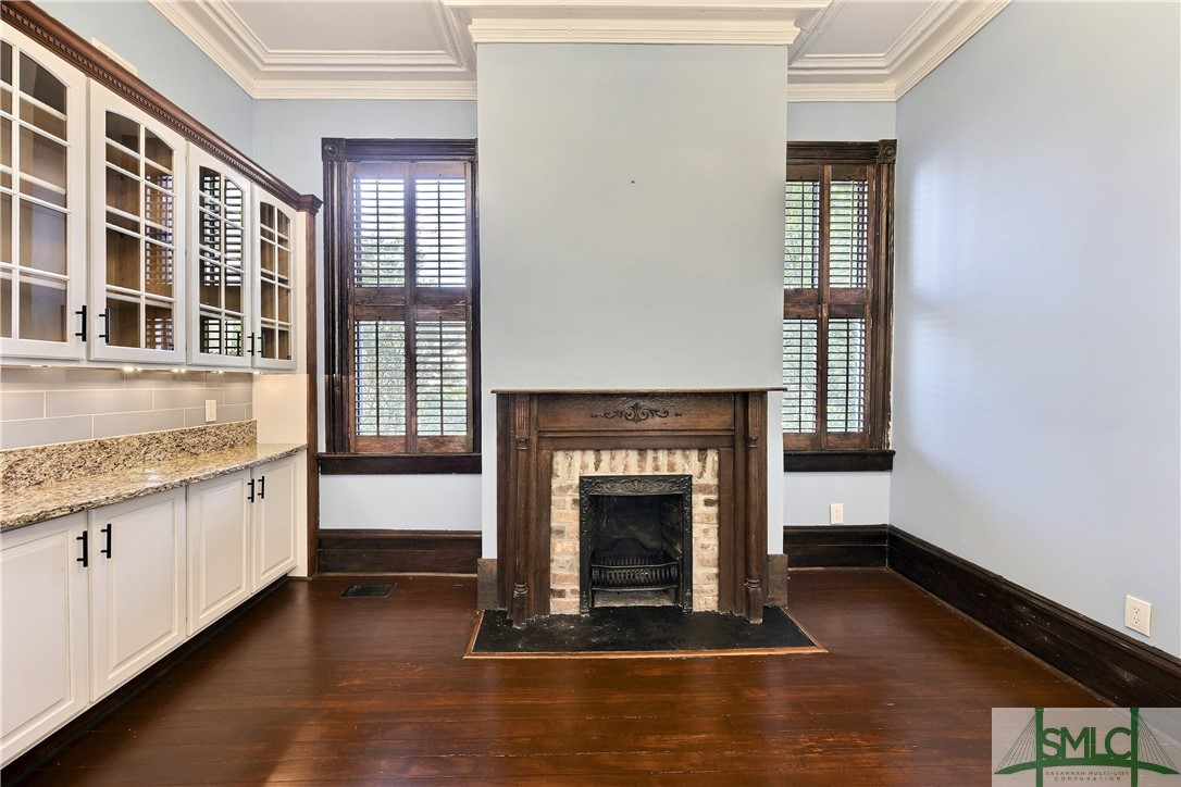 612 Barnard Street Savannah, GA 31401 - Photo 29 of 50 Additional cabinet and counter space alongside period fireplace and windows