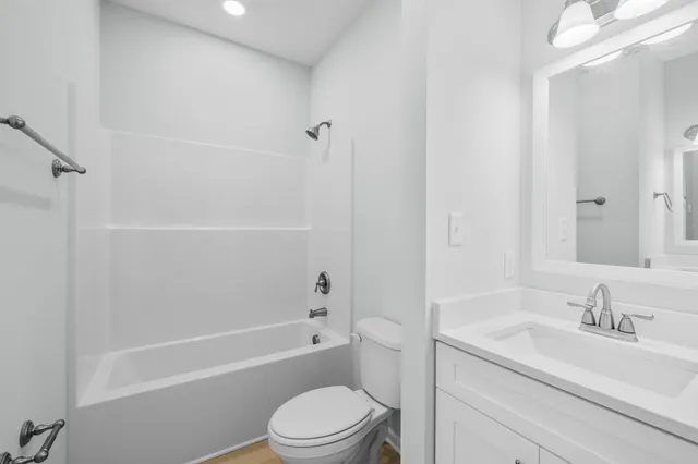 a bathroom with a sink a toilet and a bathtub