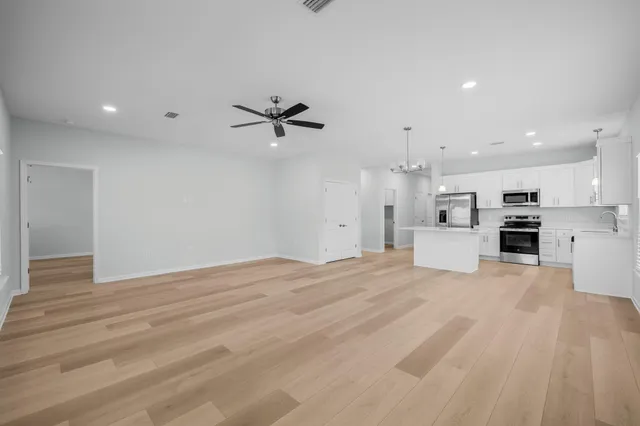 a view of a kitchen with a sink and a stove