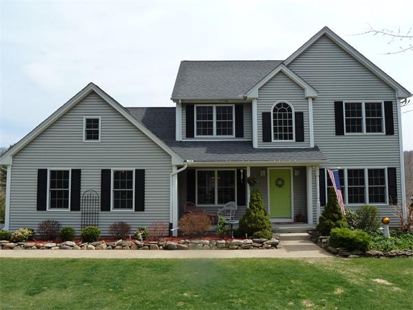 a front view of a house with a yard
