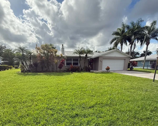 a front view of house with yard and seating area