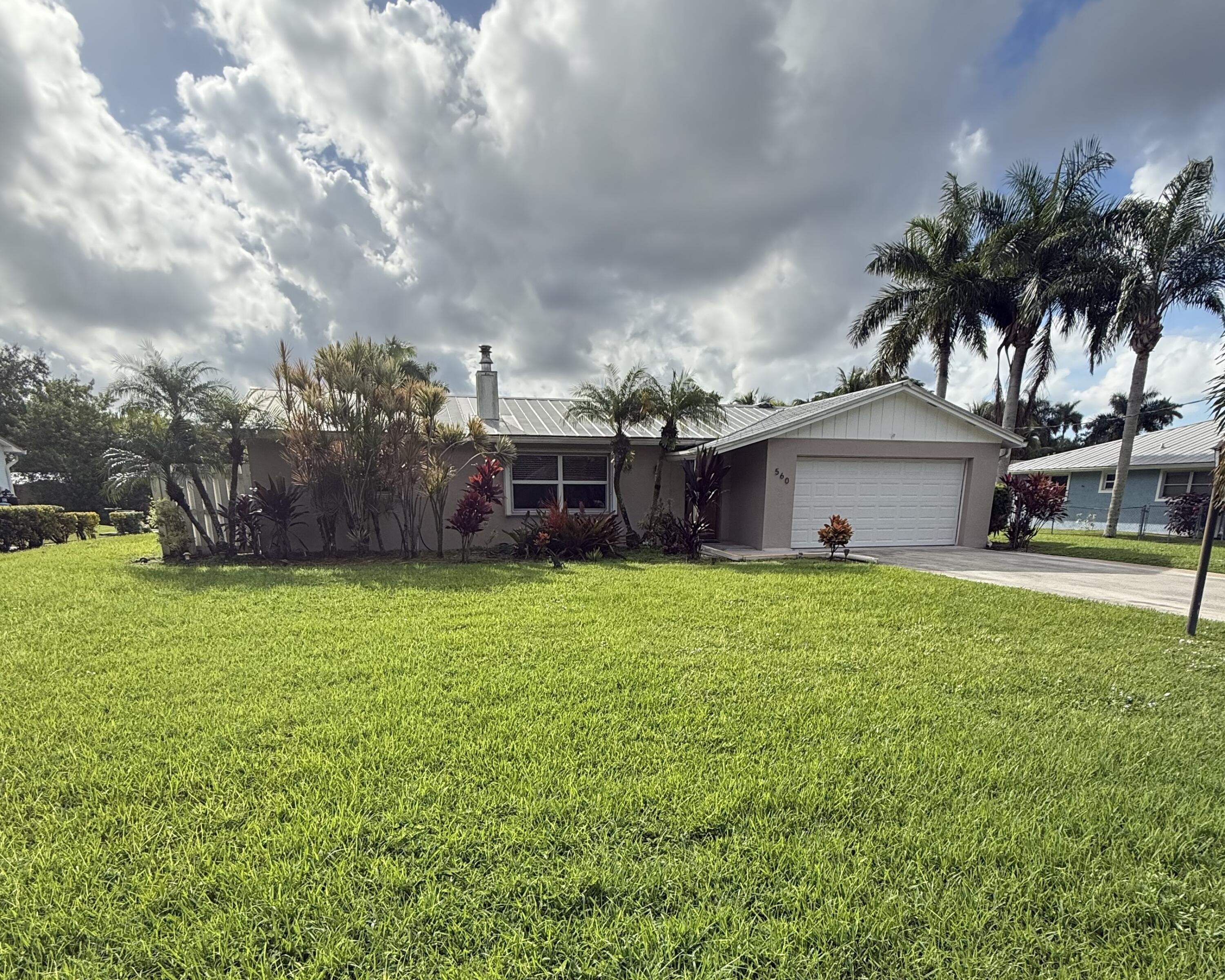 a front view of house with yard and seating area
