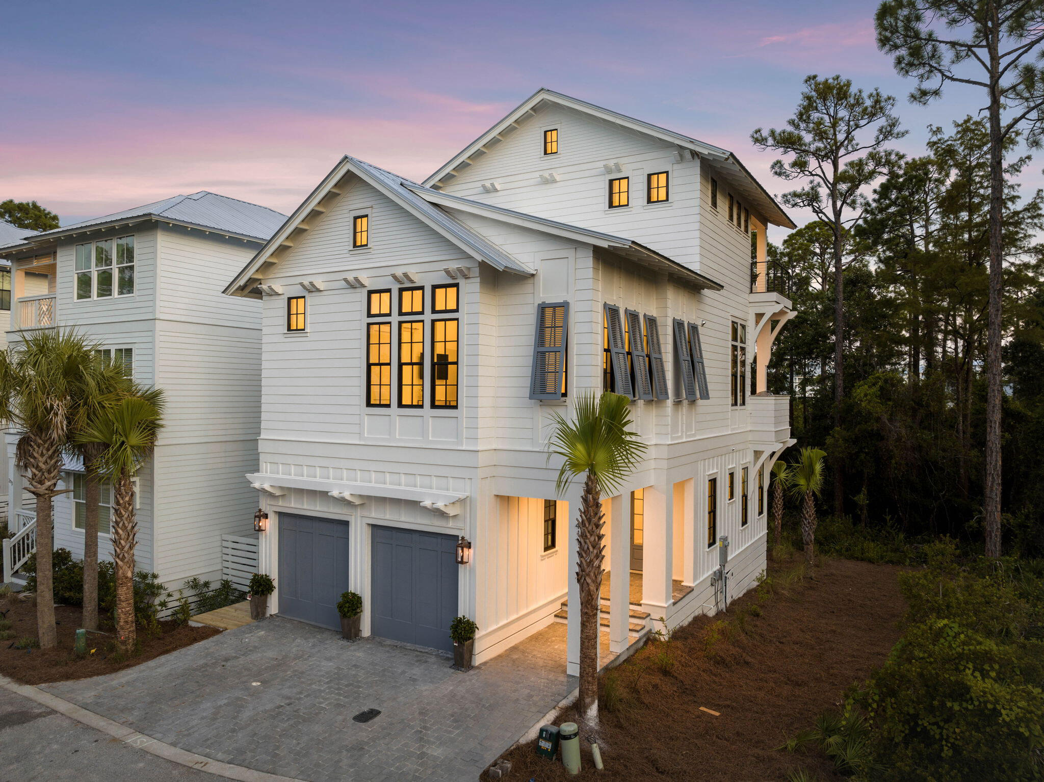 411 Redbud Ln Inlet Beach Inlet Beach, FL 32461 - Photo 1 of 53 a view of a white house with large windows and a small yard