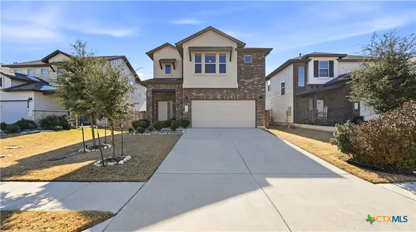 a front view of a house with yard
