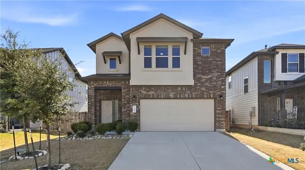 a front view of a house with parking
