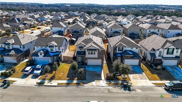 an aerial view of multiple houses with yard