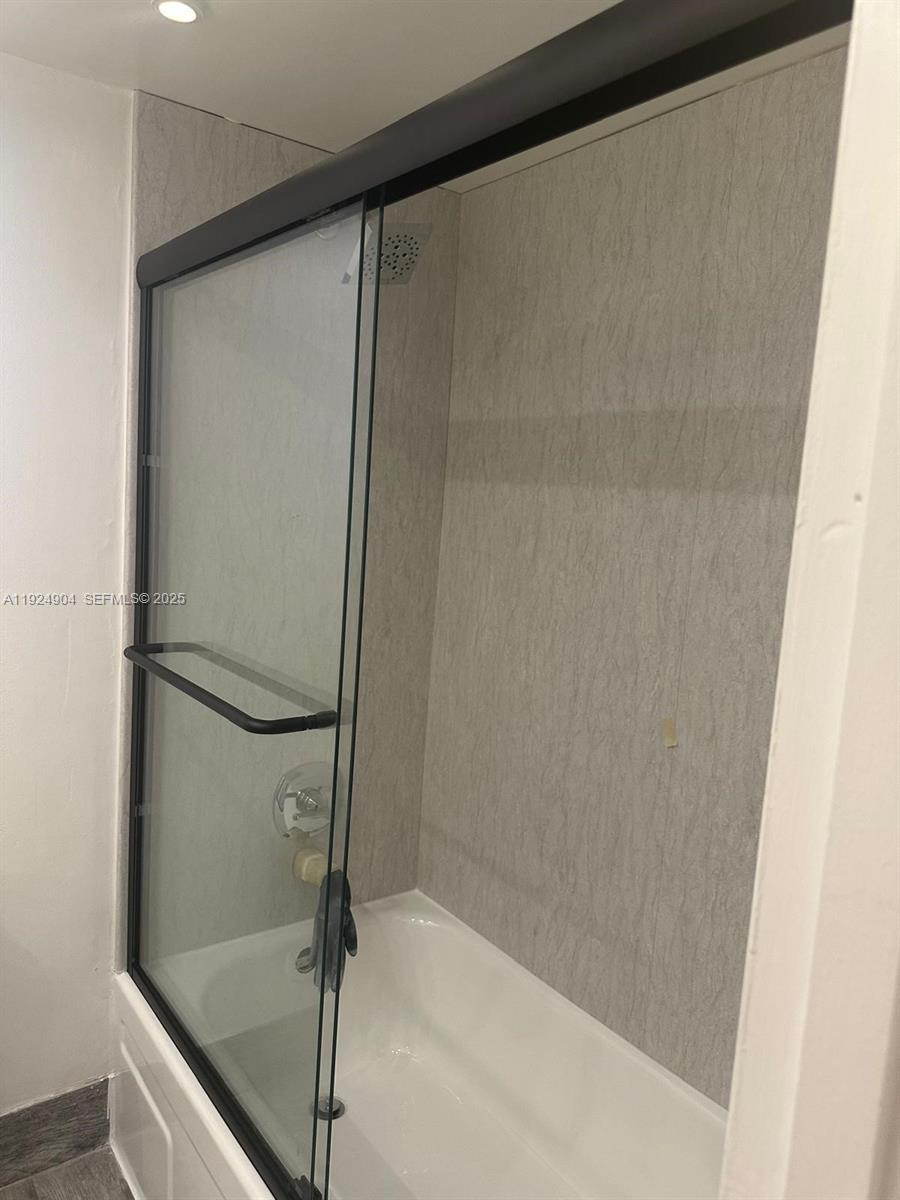 6770 Indian Creek Drive, Unit 6C Miami Beach, FL 33141 - Photo 13 of 19 a bathroom with a glass shower door