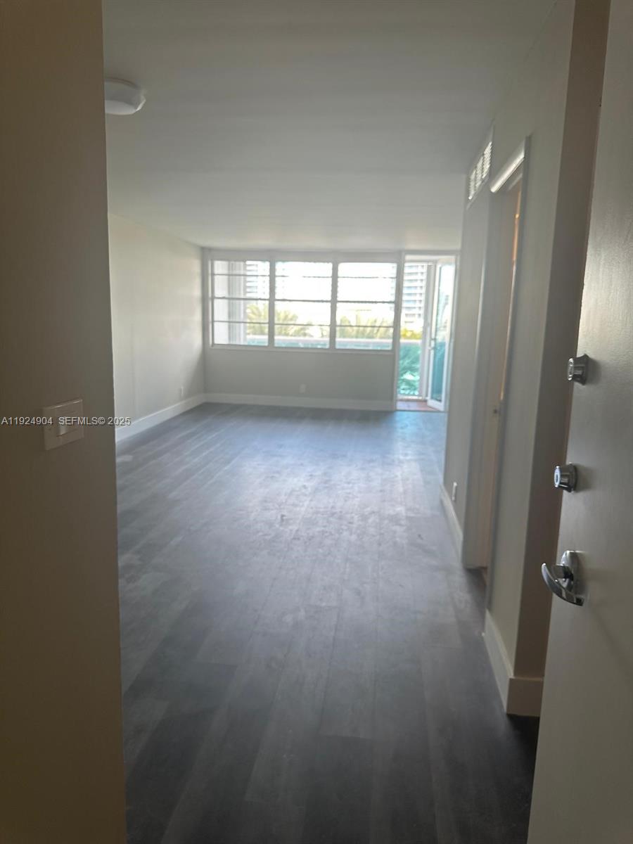6770 Indian Creek Drive, Unit 6C Miami Beach, FL 33141 - Photo 6 of 19 an empty room with windows