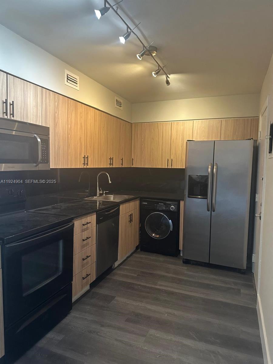 6770 Indian Creek Drive, Unit 6C Miami Beach, FL 33141 - Photo 8 of 19 a kitchen with stainless steel appliances granite countertop a refrigerator and a sink