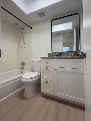 a bathroom with a toilet a sink and bathtub