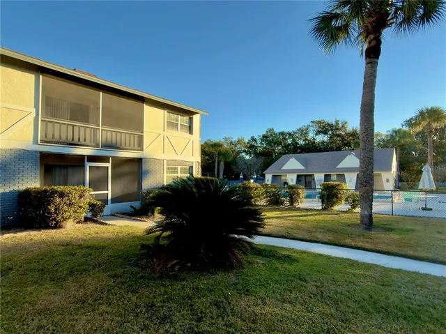 a front view of a house with a garden and patio