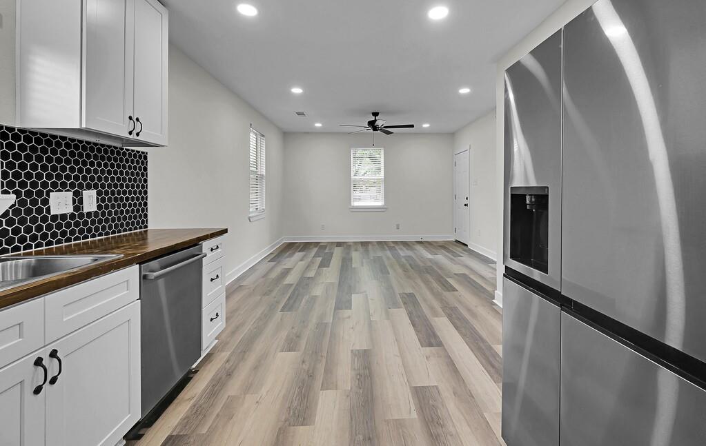 1713 Reuter Avenue Waco, TX 76708 - Photo 12 of 34 Kitchen with appliances with stainless steel finishes, butcher block countertops, recessed lighting, decorative backsplash, and a ceiling fan
