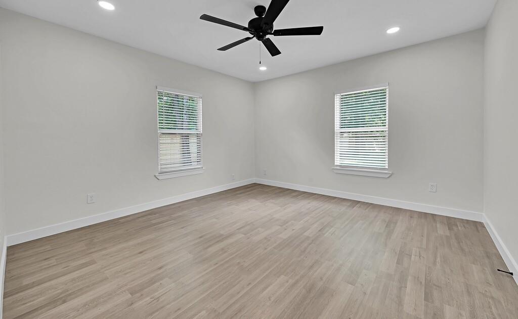 1713 Reuter Avenue Waco, TX 76708 - Photo 13 of 34 Spare room with light wood-style flooring, baseboards, a ceiling fan, and recessed lighting