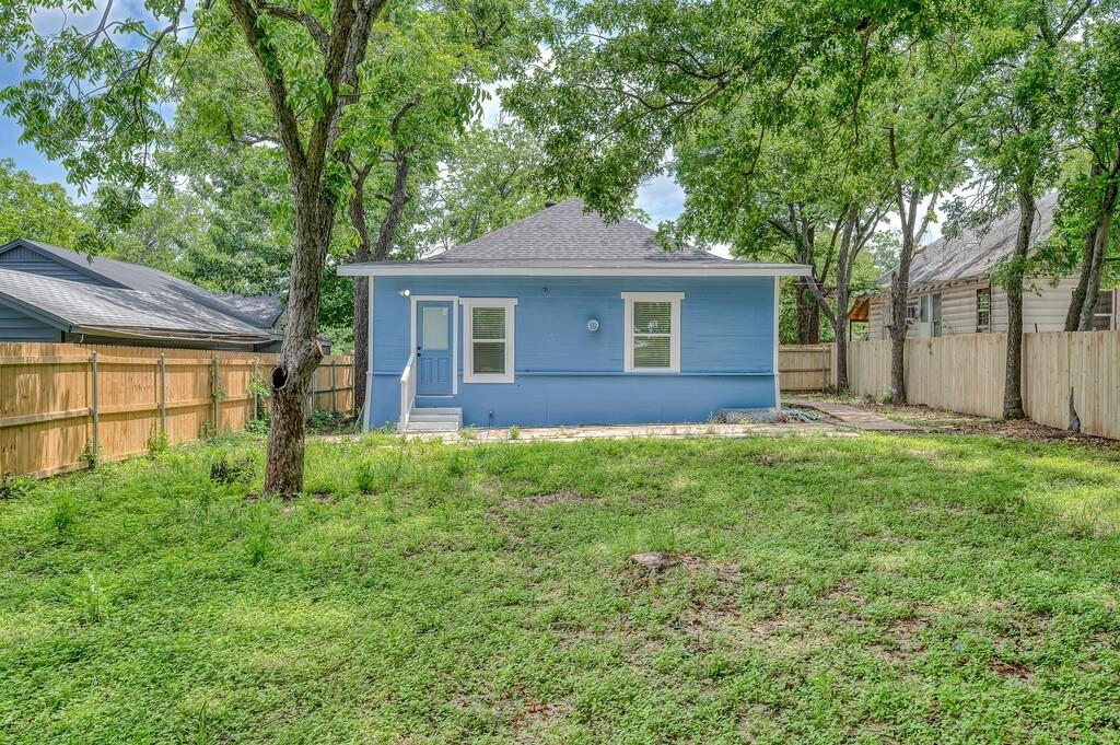 1713 Reuter Avenue Waco, TX 76708 - Photo 31 of 34 Back of house featuring a shingled roof and entry steps