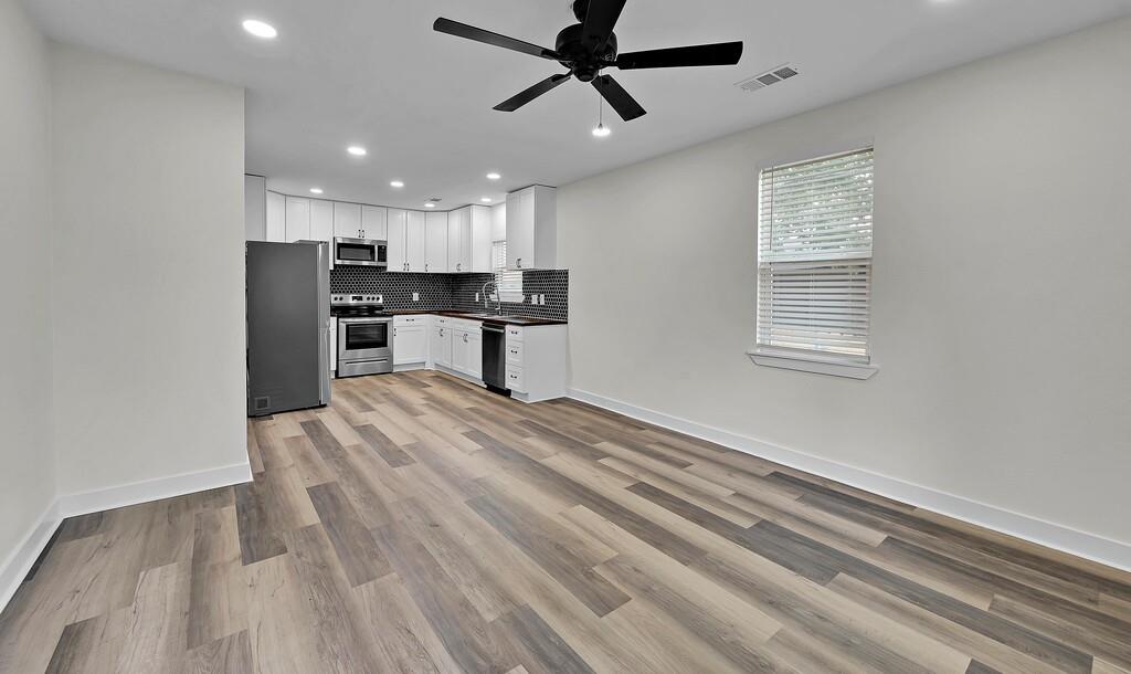 1713 Reuter Avenue Waco, TX 76708 - Photo 4 of 34 Kitchen featuring appliances with stainless steel finishes, a ceiling fan, recessed lighting, decorative backsplash, and baseboards