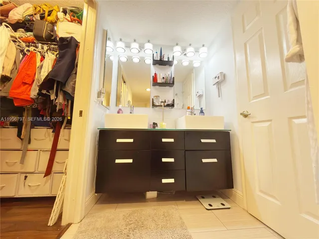 a bathroom with a sink vanity and a mirror