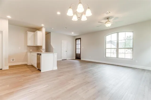 a view of a kitchen with a stove cabinets and wooden floor