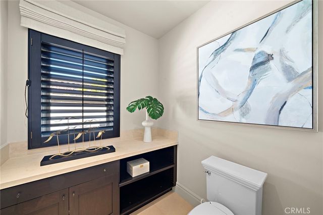 a view of a patio with table and chairs and potted plants
