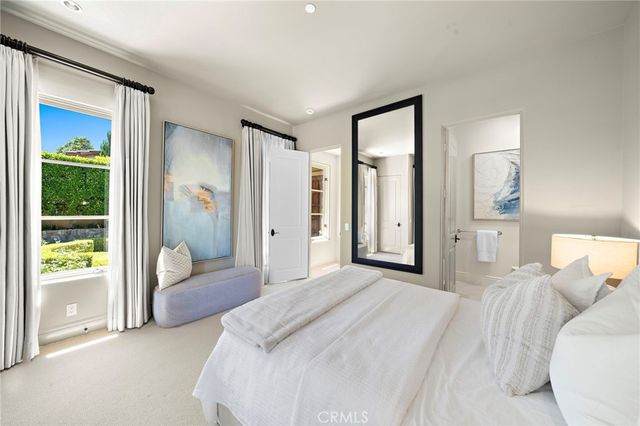 an outdoor view of a house with lake view and a car parked