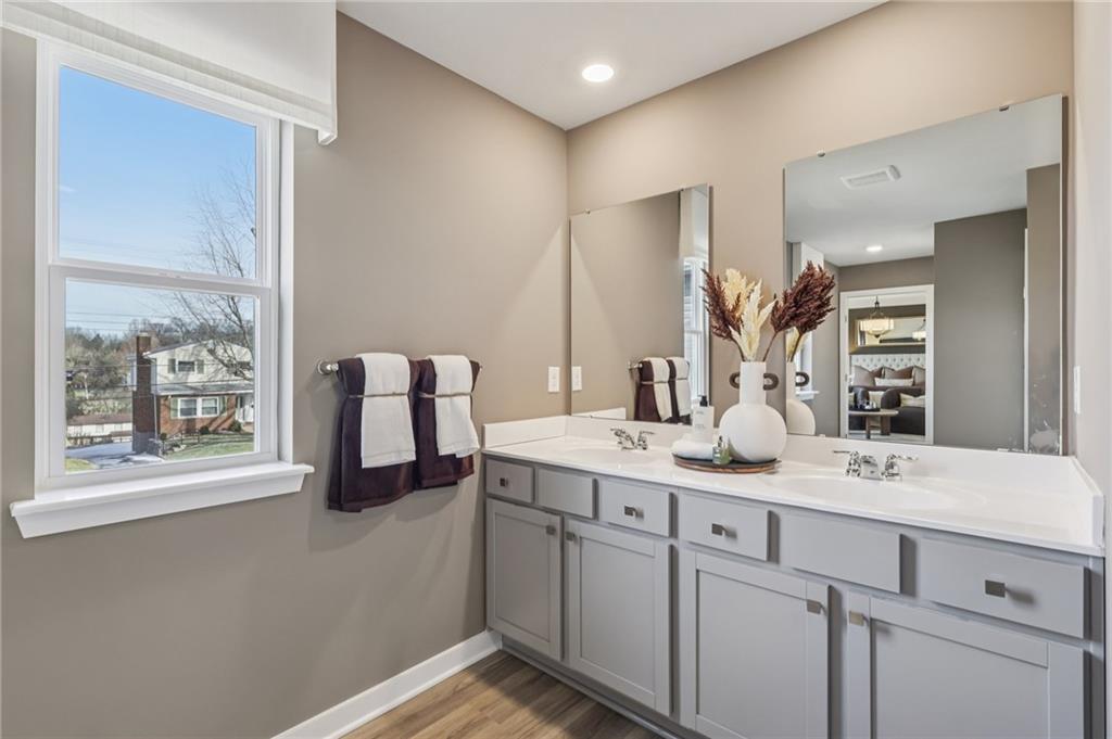 1083 Peachtree Road Carnegie, PA 15106 - Photo 26 of 30 a en suite bathroom with a double vanity sink and mirror