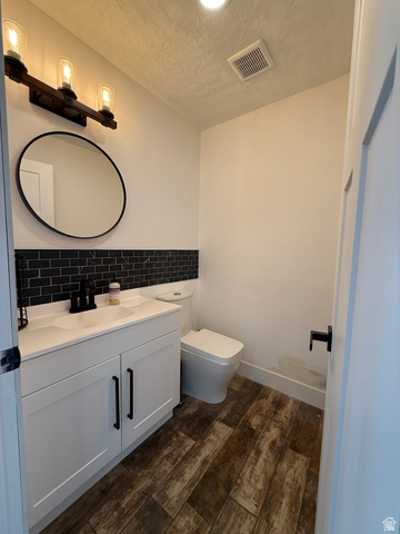965 North 800 East Springville, UT 84663 - Photo 20 of 46 Half bath with vanity, dark wood-style floors, and a textured ceiling