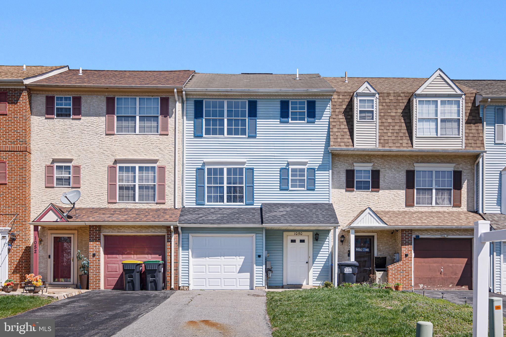 a front view of a residential apartment building with a yard