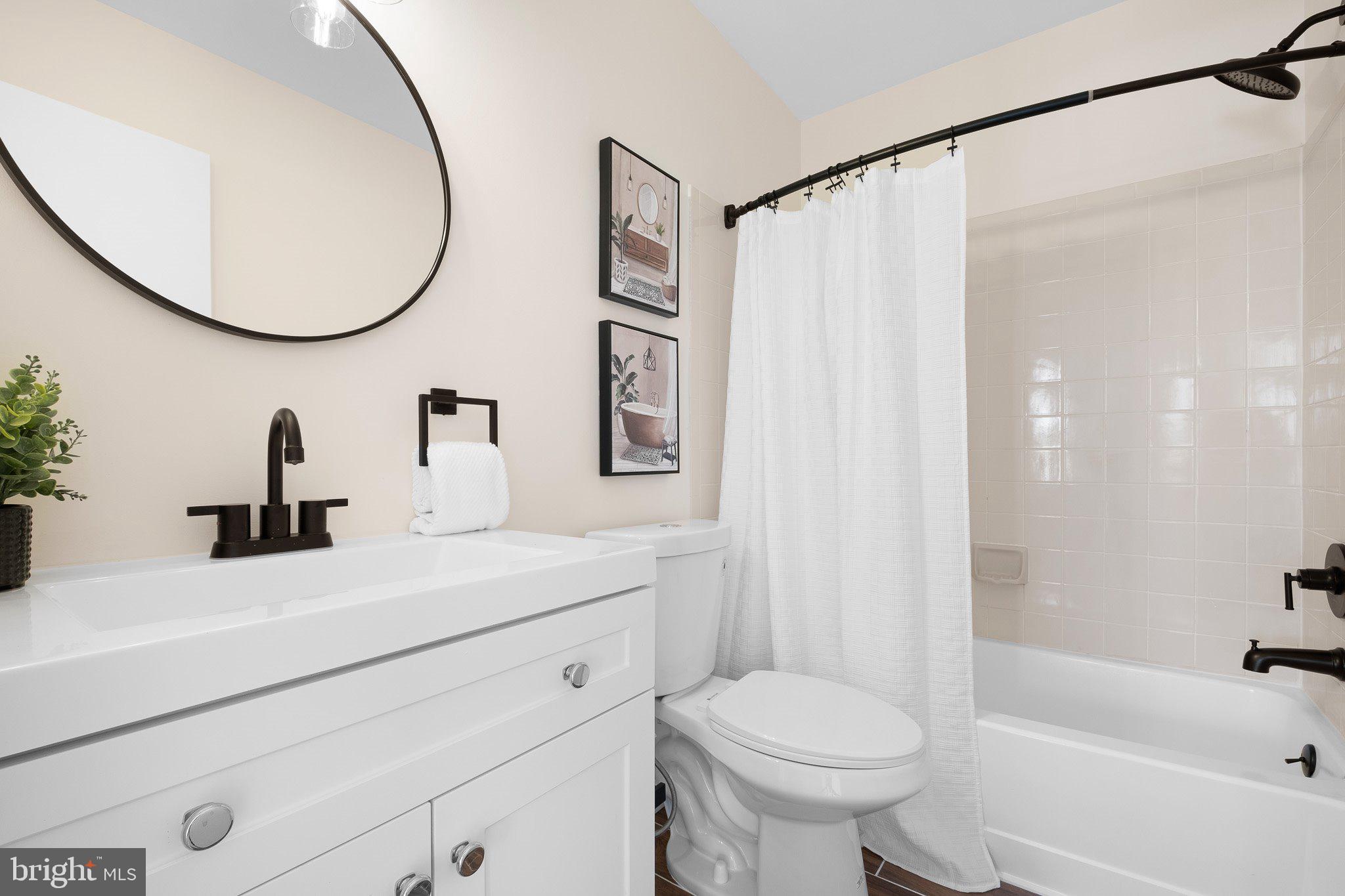 1050 Old Forge Road New Castle, DE 19720 - Photo 14 of 25 a bathroom with a sink a toilet and a mirror