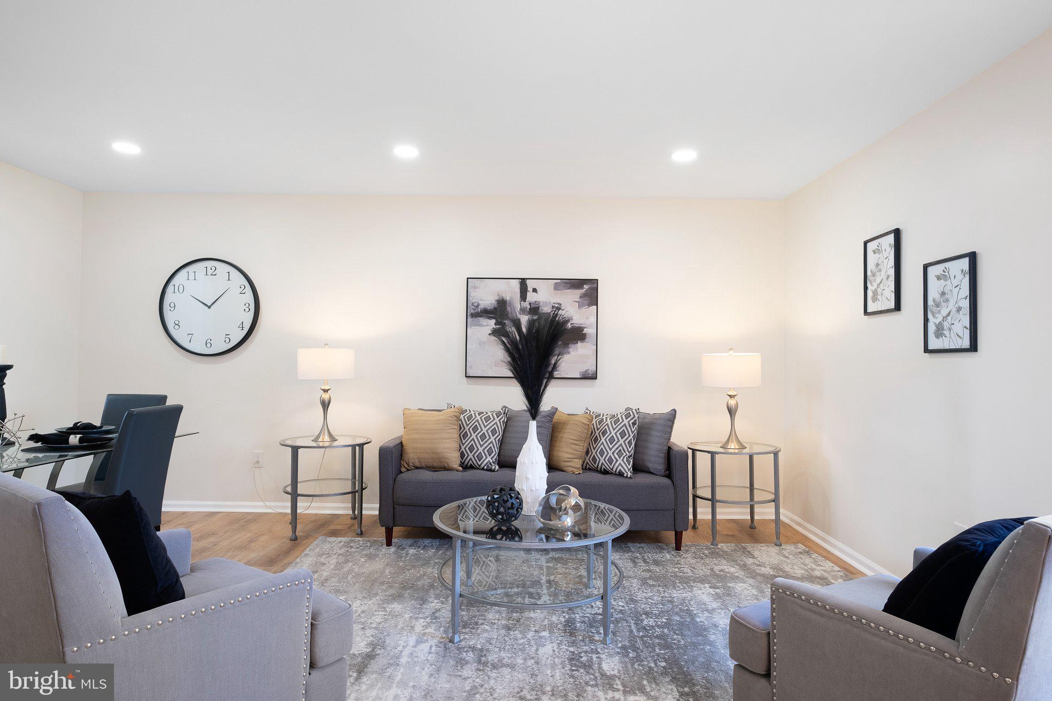 1050 Old Forge Road New Castle, DE 19720 - Photo 4 of 25 a living room with furniture a clock and white walls