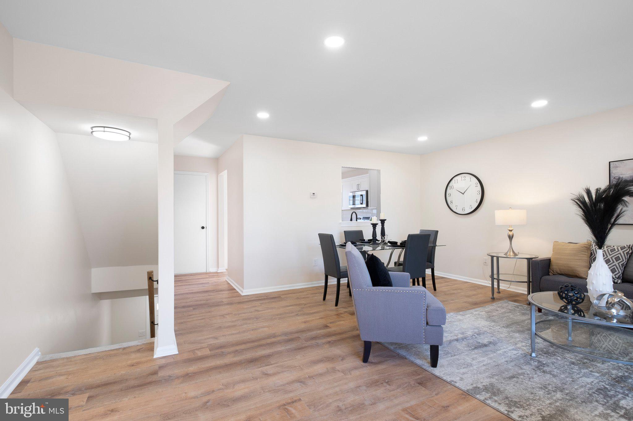 1050 Old Forge Road New Castle, DE 19720 - Photo 8 of 25 a dining room with wooden floor a glass table and chairs