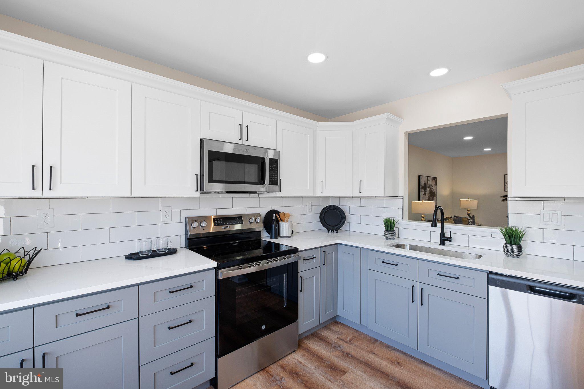 1050 Old Forge Road New Castle, DE 19720 - Photo 10 of 25 a kitchen with a sink stove and cabinets