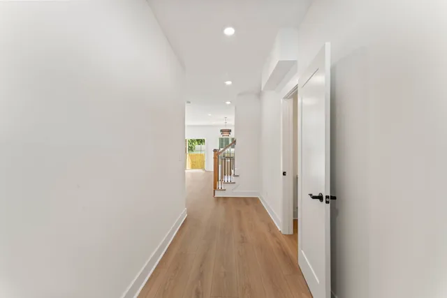 a view of a hallway with wooden floor