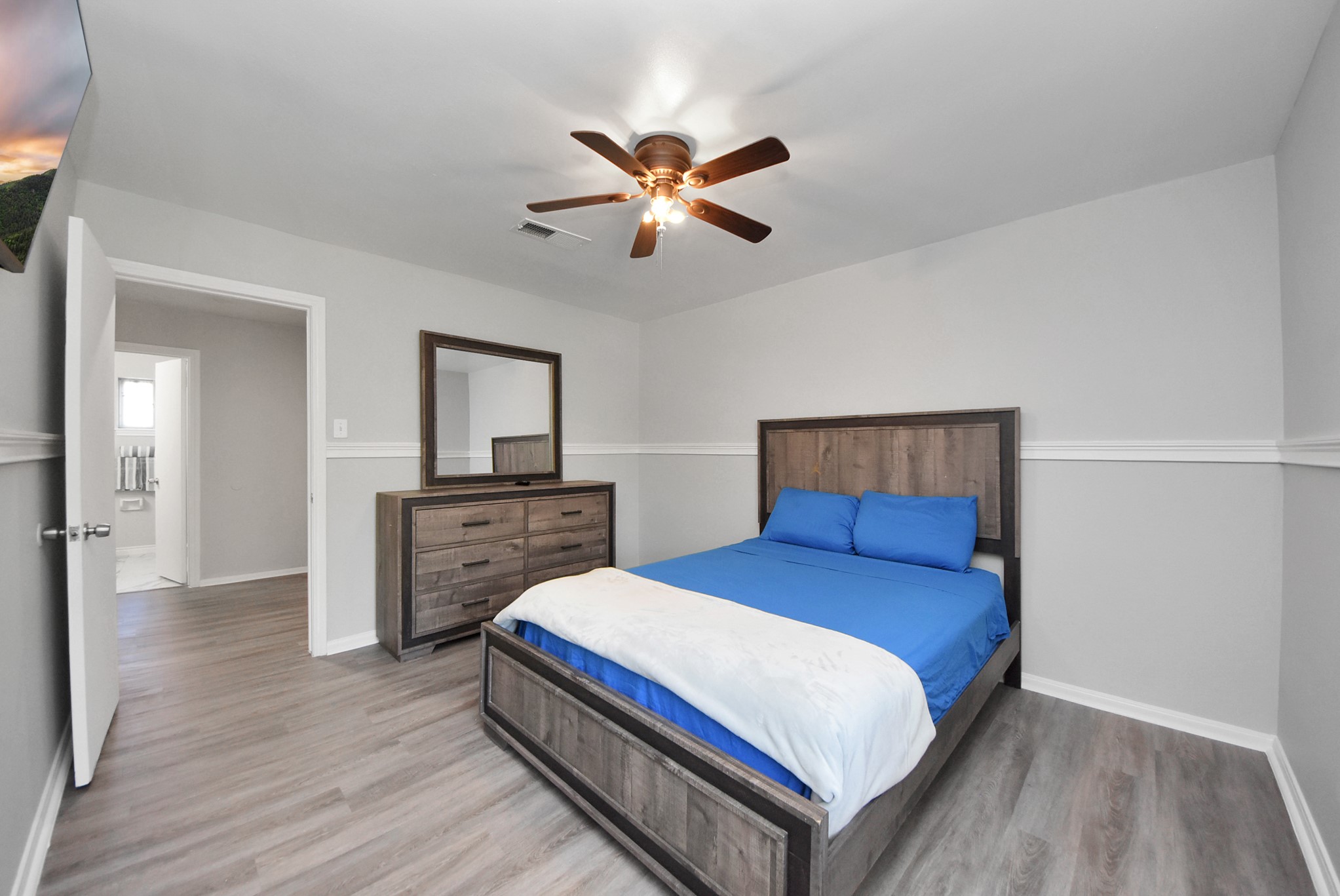 1011 Whitestone Lane Houston, TX 77073 - Photo 16 of 48 a bedroom with a bed and a chandelier