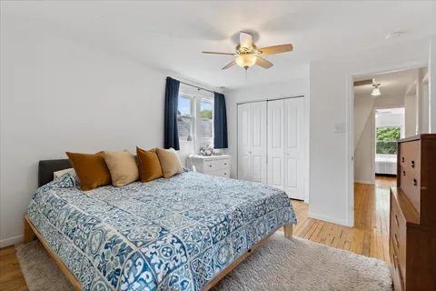 a bedroom with a large bed and a chandelier