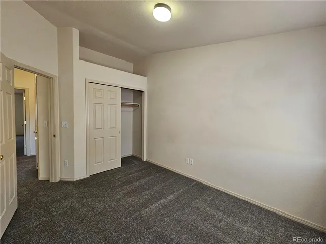 an empty room with closet area