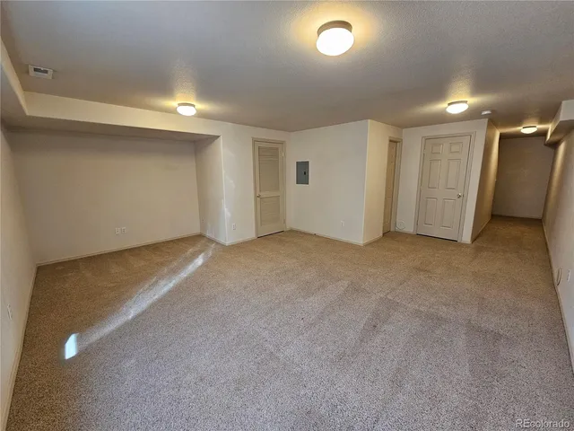 en empty room with windows and entrance