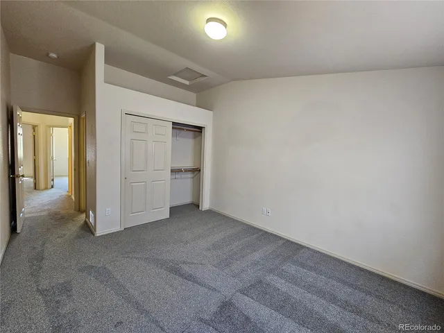 an empty room with closet area