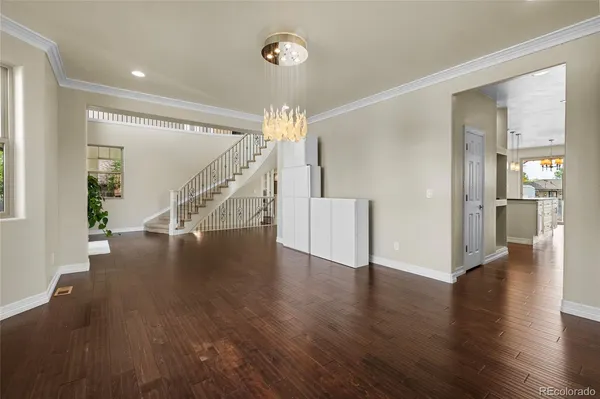 a view of an entryway with wooden floor and a livingroom