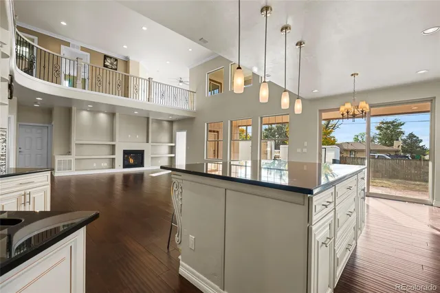 a kitchen with stainless steel appliances granite countertop a stove and a wooden floors