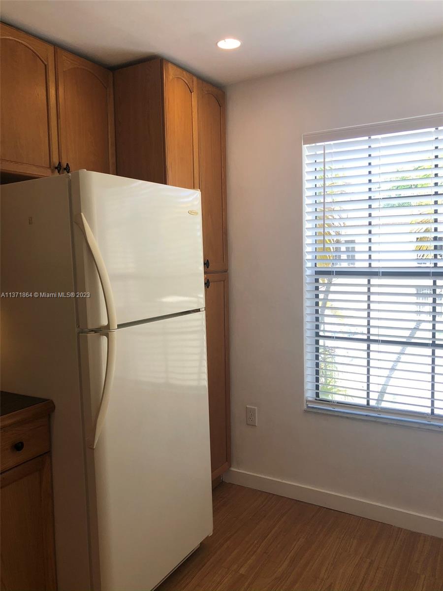 12902 Southwest 88th Terrace, Unit B201 Miami, FL 33186 - Photo 22 of 49 a white refrigerator freezer sitting in a kitchen