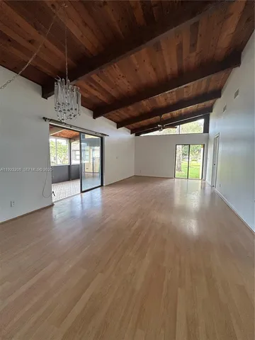 a living room with furniture a table and a flat screen tv