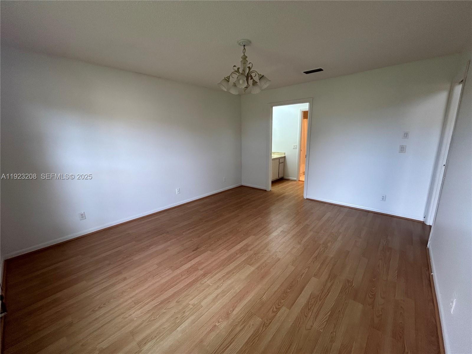 534 Briarwood Circle, Unit 148 Hollywood, FL 33024 - Photo 17 of 40 an empty room with wooden floor and windows