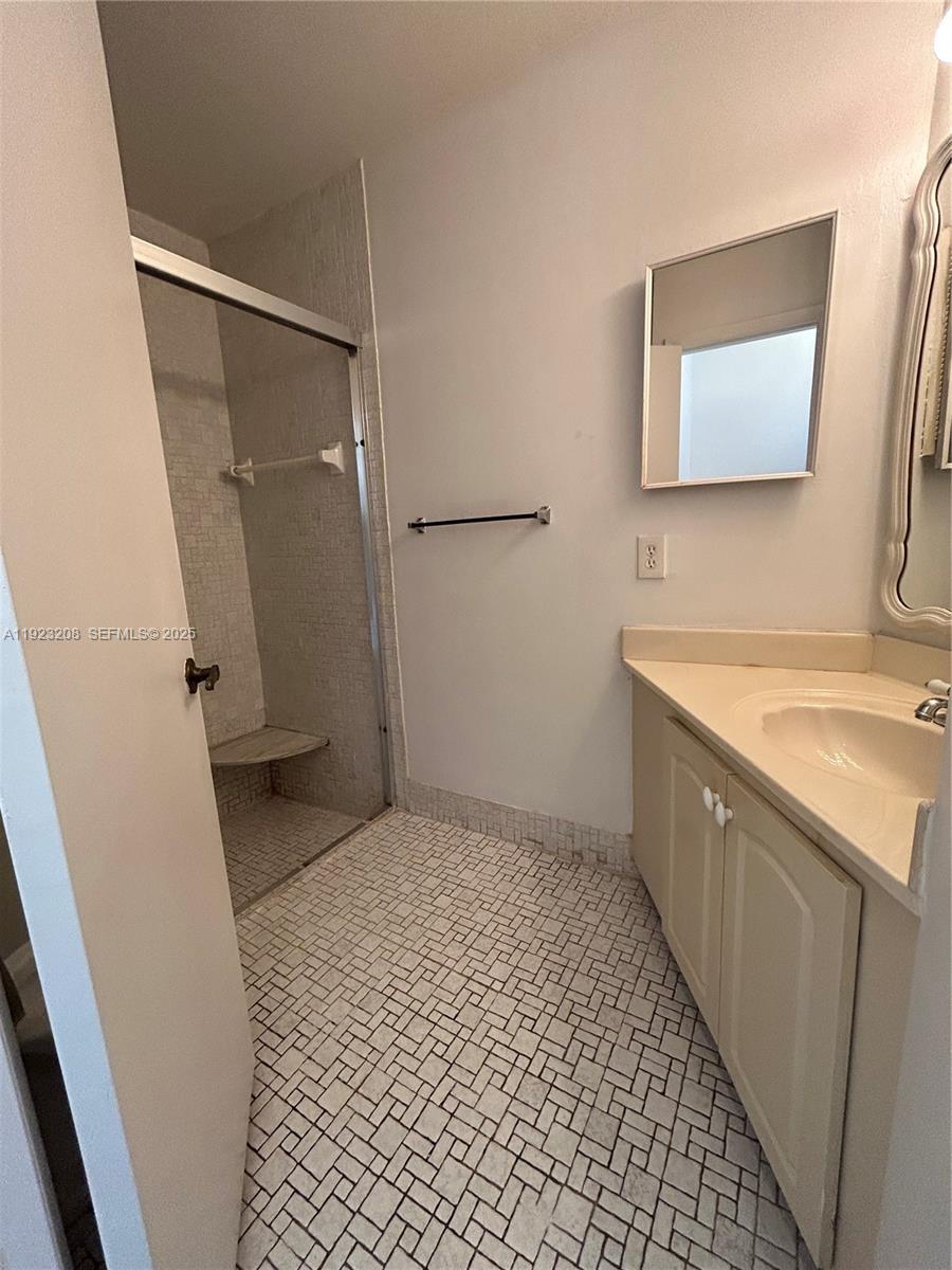 534 Briarwood Circle, Unit 148 Hollywood, FL 33024 - Photo 20 of 40 a bathroom with a sink a toilet and a mirror