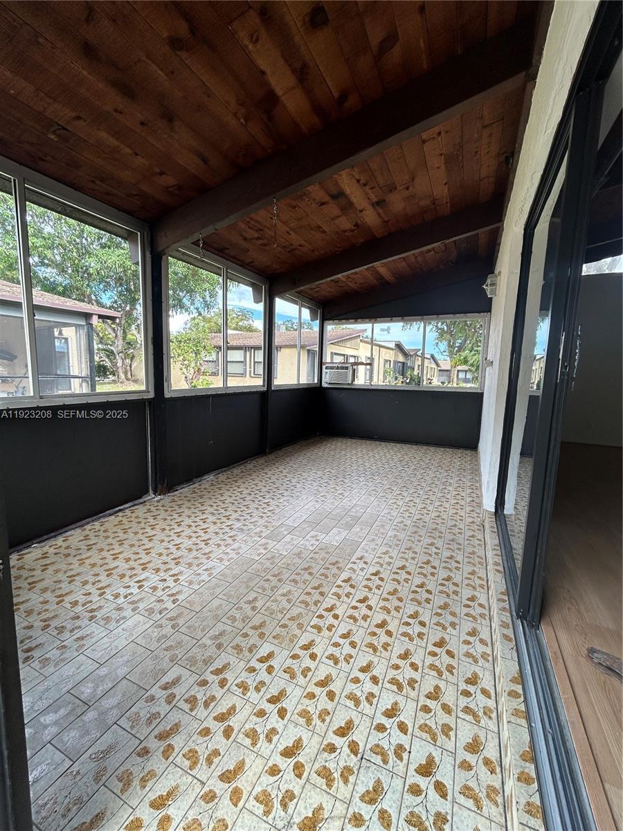 534 Briarwood Circle, Unit 148 Hollywood, FL 33024 - Photo 23 of 40 a view of empty room with wooden floor and fan