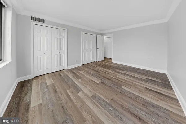 a view of wooden floor and entryway in a room