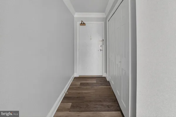 a view of a hallway with wooden floor