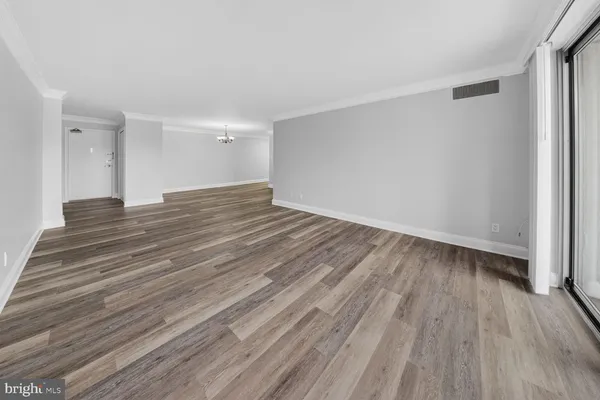 a view of wooden floor and windows in a room