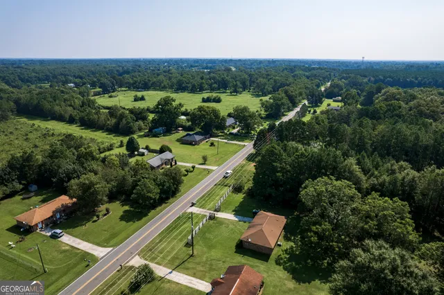 an aerial view of a house with a yard