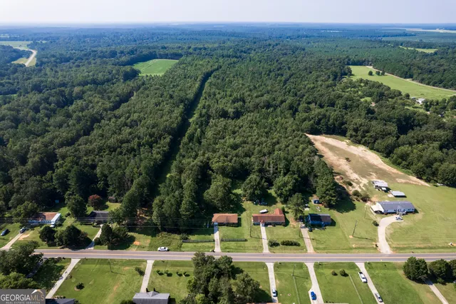 an aerial view of house with a yard