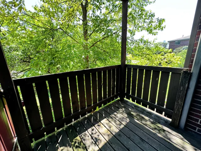 a view of balcony with wooden floor