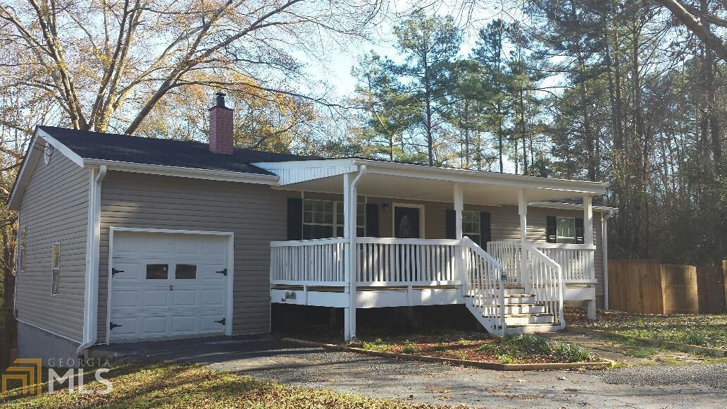 54 Redwood Valley Road Stockbridge, GA 30281 - Photo 1 of 1 a front view of house with yard garage and furniture